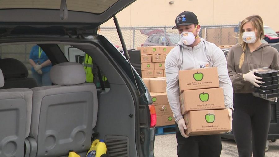Houston Astros star third baseman Alex Bregman helps give food for the needy